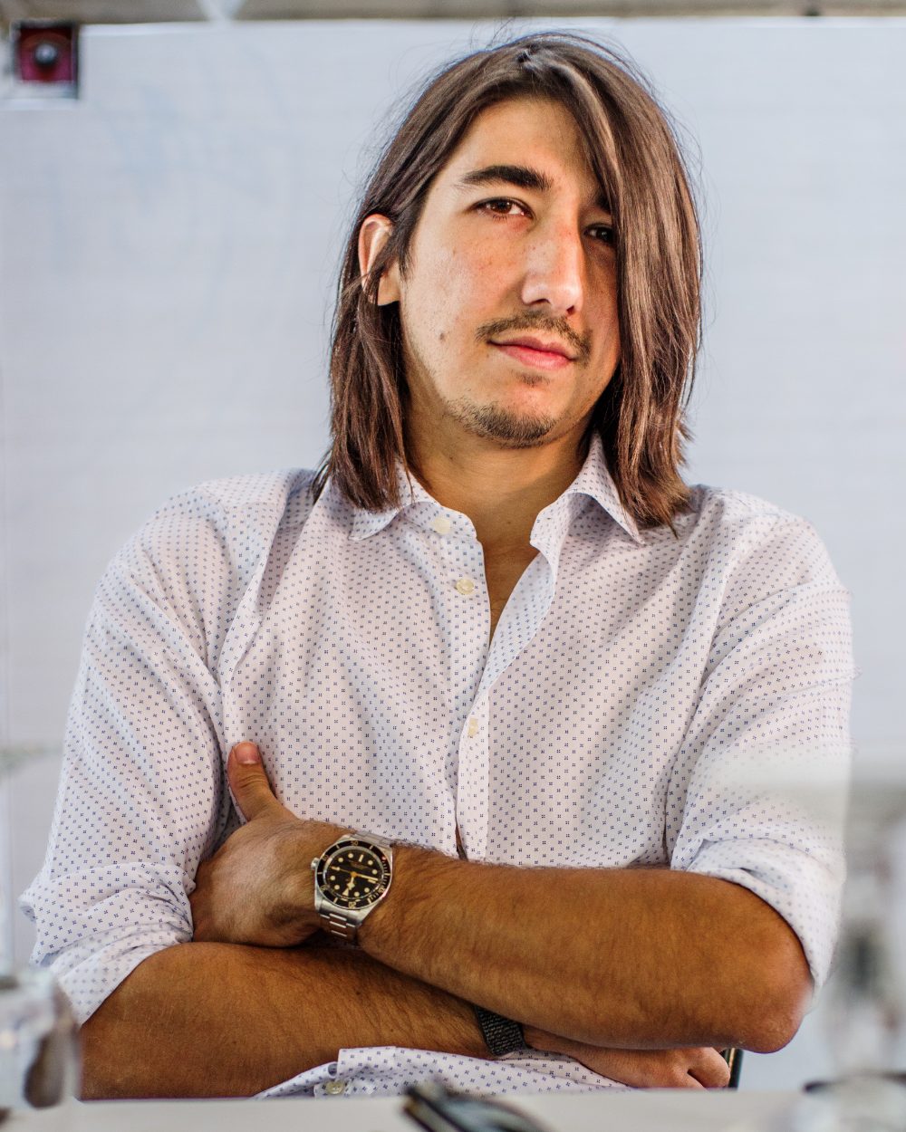 Julien Clifford, arms folded, photographed in the studio.