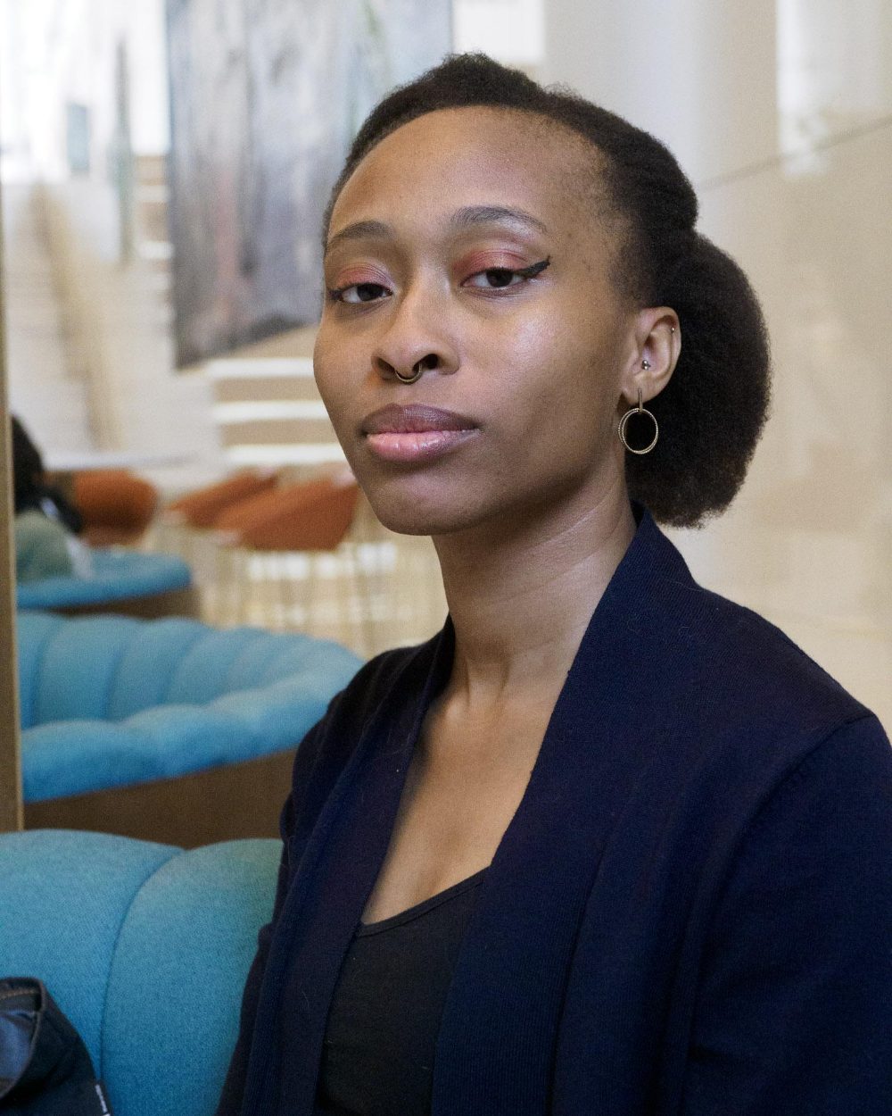 Franky Ervin, seated, photographed in a lobby.
